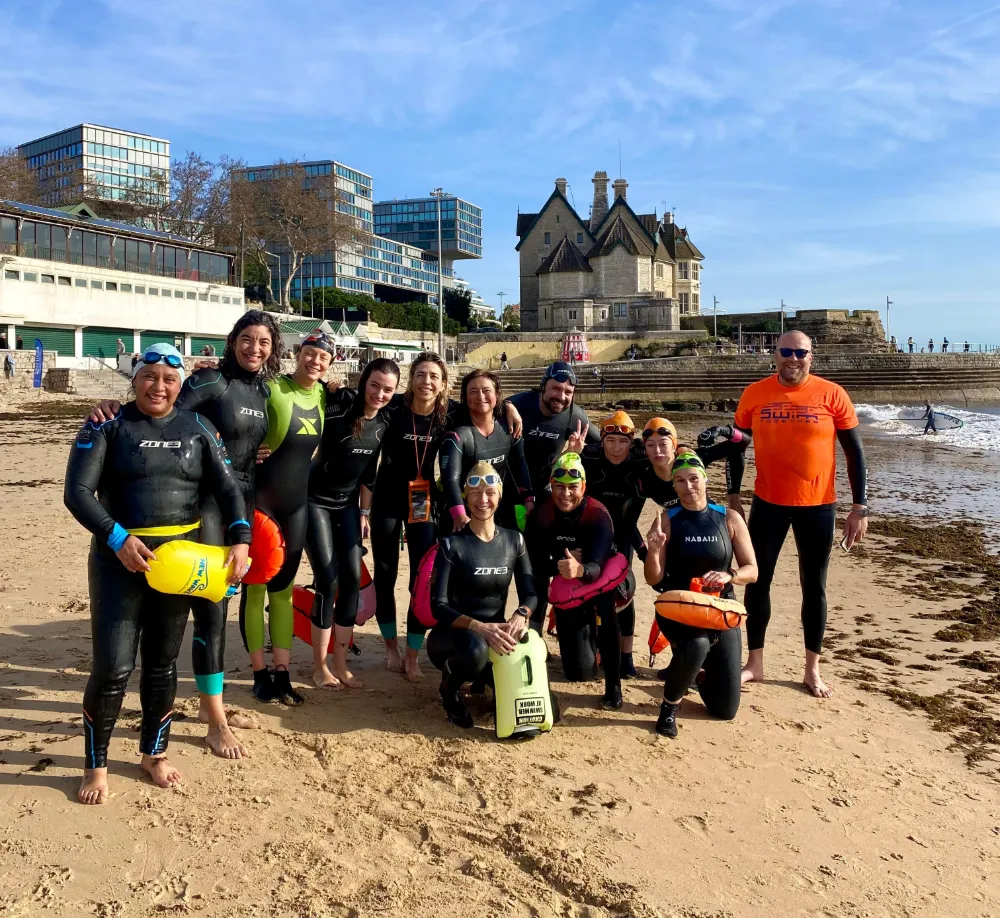 womesn group taking photo on beach after swim