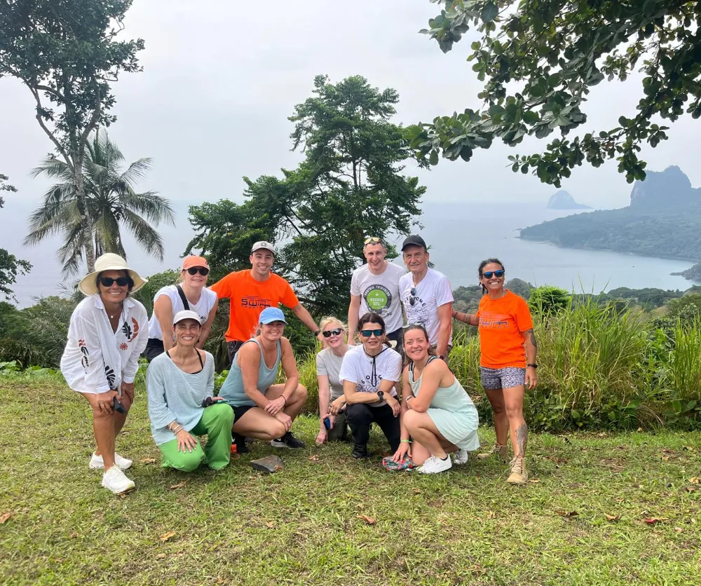 group of people taking photo with ocean as background