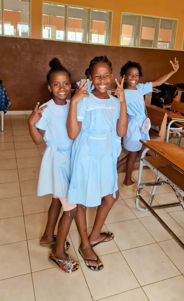 three girls with blue dresses