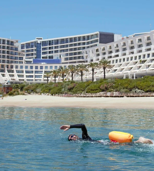 Swimming in California's white sand beach in Sesimbra surrounded by palm trees and- ice weather
