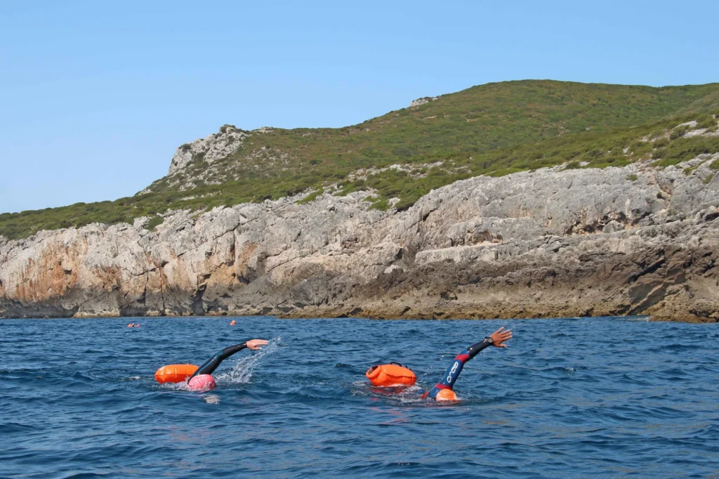 Two swimmers swimming around Cabo Espichel in Sesimbra