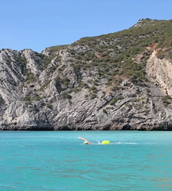 Swimming vacation in the clear turquoise waters of a paradisiacal beach