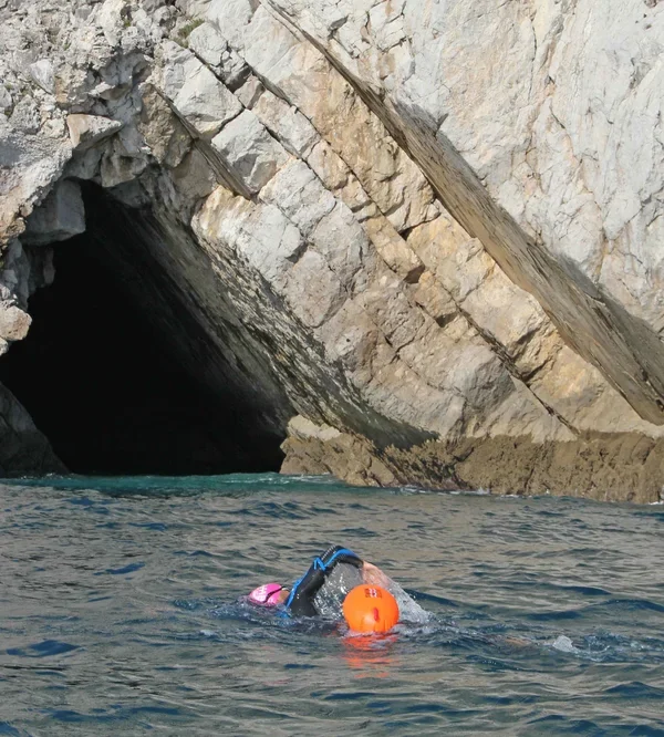Open water swimmer entering an endless cave on the portuguese coast